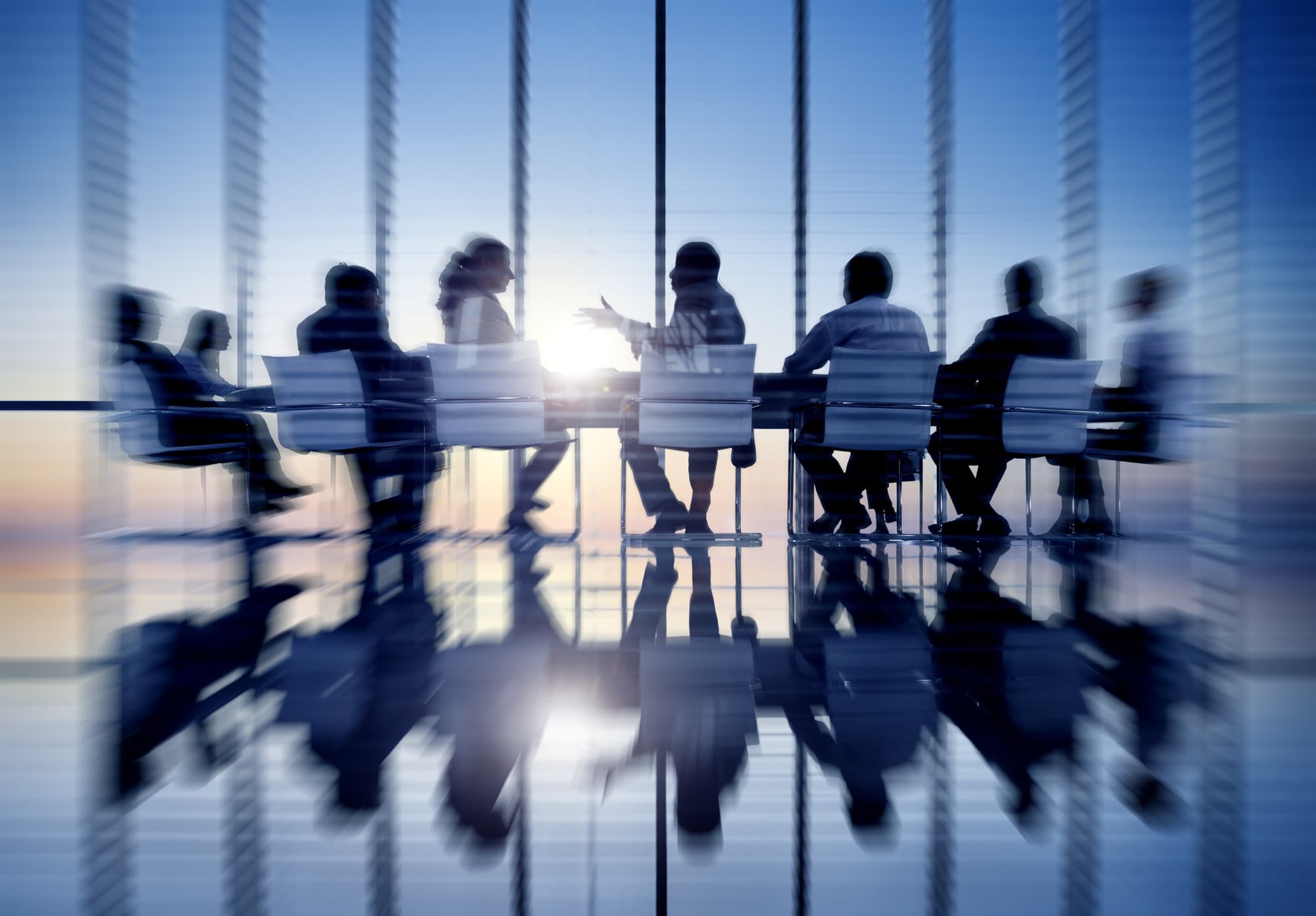 business people sat at board table